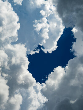 Clouds in the sky with a hole showing deep blue sky