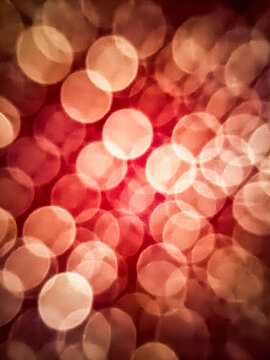 Defocused points of light against a red background