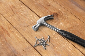 hammer hand tool on wooden background