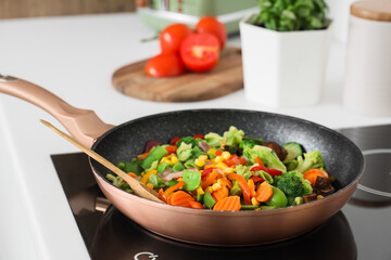 Frying pan with tasty vegetables in kitchen, closeup