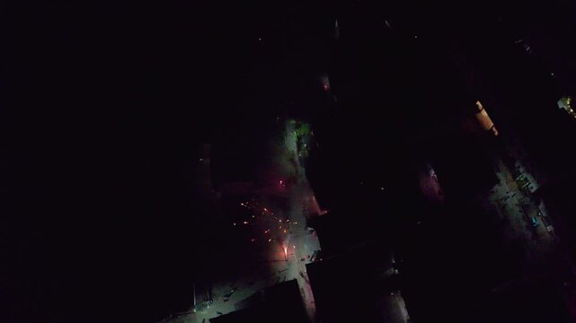 Drone view of fireworks set off during New Year celebrations in Wuyuan, Jiangxi, China. Top view of colorful fireworks in rural China in spring festival at night, 4k real time footage.