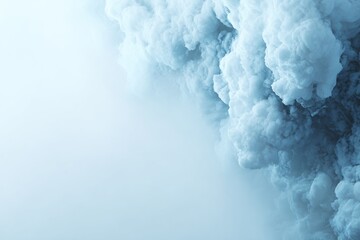 Naklejka premium Dense swirling mass of light-blue smoke filling the right frame