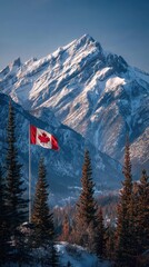Majestic snow-capped mountains rise behind a waving Canadian flag under a clear blue sky in winter