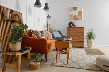 Interior of living room with record player, sofa and lamps