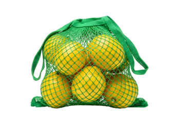 A vibrant green mesh produce bag is filled with bright yellow citrus fruits against a striking black background.