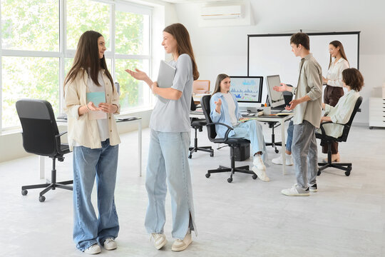 Female students with notebooks at school computer lab
