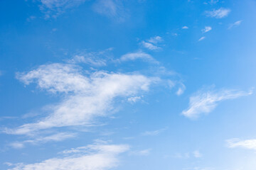 the sky is clear and bright and the clouds are scattered throughout the sky. blue sky with white clouds.