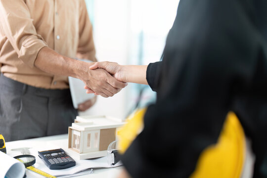 Professional Agreement. Engineer and architect shaking hands on project deal.