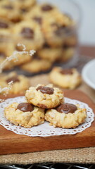 Homemade chocolate thumbprint cookies with peanut sprinkles and with hot black coffee, isolated on a clean white background. 
