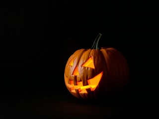 Fototapeta premium Glowing jack o lantern with a spooky face on a dark background