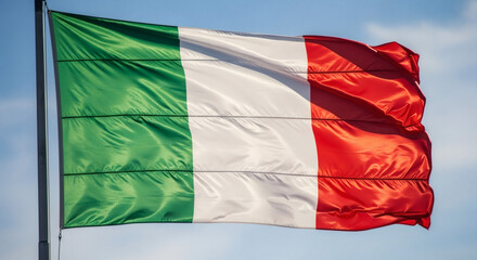 Obraz premium A close up of the italian flag waving in the wind against a clear blue sky on a bright sunny day