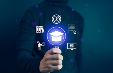 Hand holding magnifying glass with digital graduation cap icon, symbolizing online education, e-learning platform, academic research, knowledge development, and innovative study technology.