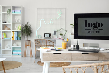 Graphic designer's workplace with computer and tablet in office