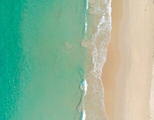 Aerial view of turquoise water meeting beige beach