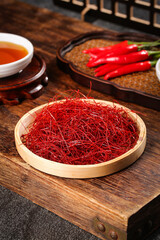 Finely Shredded Dried Red Chili Peppers in Wooden Bowl Display