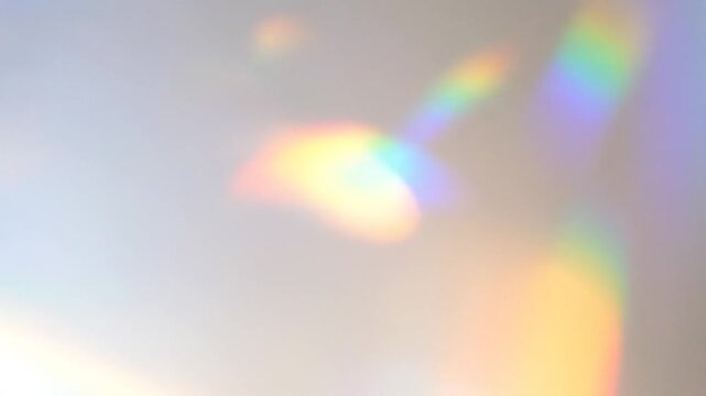 Shimmering Rainbow Light Leaks: Abstract Prism Effects on White Wall