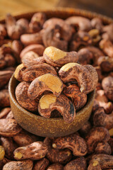 Roasted Cashew Nuts with Brown Skin in Wooden Bowl - Healthy Organic Snack Food Ingredient