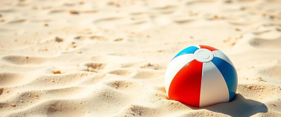 Obraz premium Vibrant beach ball rests on sun-drenched sand, summer fun implied, colorful, background