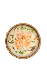 Seafood congee with shrimp and mushrooms in wooden bowl on white background