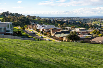 Suburban neighborhood in Highton, Geelong, regional Victoria, Australia, with modern homes on a hillside and green open space. Concept of livable suburbs, comfortable housing, and community lifestyle. © Doublelee