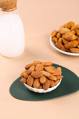 Raw Almonds in Bowl with Milk Bottle - Healthy Nuts Snacks Natural Food Photography