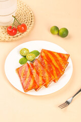 Spicy Grilled Ribs with Lime and Fresh Garnish on White Plate