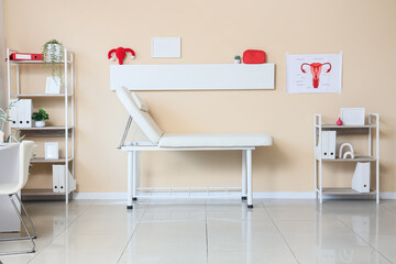 Interior of gynecologist's office with couch and shelf units