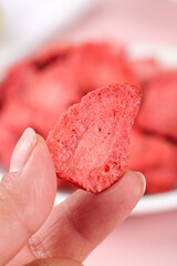 Freeze-Dried Strawberry Slice in Hand - Healthy Snack Food with Shallow Focus