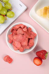 Freeze-Dried Strawberry Snacks with Fresh Fruits on Pink Background