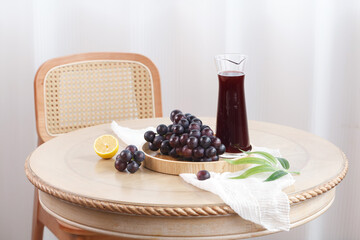 Fresh Grape Juice with Dark Grapes and Lemon on Wooden Table Summer Drink Setup