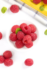 Fresh Red Raspberries with Mint in White Bowl on Kitchen Towel - Healthy Organic Berry Food Photography