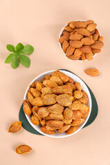 Raw and Roasted Almonds in Bowls with Mint Leaves - Healthy Nuts Snack Food