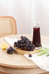 Fresh Dark Grapes and Juice on Wooden Board - Healthy Summer Fruit Scene with Bright Natural Light