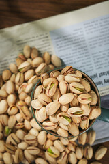 Fresh Pistachios in Bowl on Newspaper - Healthy Daily Snack Food Photography