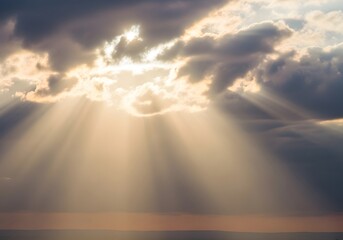 Dramatic golden sun rays pierce through dark, stormy clouds, casting beautiful light over the distant horizon at dusk