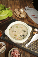 Savory Rice Porridge with Mushrooms and Fresh Ingredients on Rustic Wooden Table - Healthy Breakfast Meal