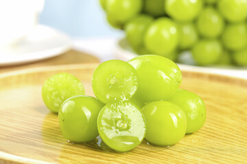 Fresh Green Grapes Cut in Half on Wooden Board - Healthy Fruit Food Photography
