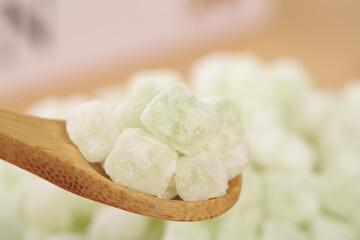 Green Melon Rock Candy Crystals on Wooden Spoon - Traditional Granulated Sugar Confection