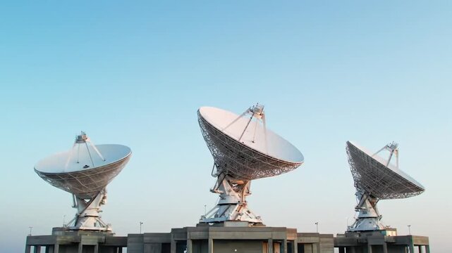 Three Large White Radio Telescopes Under a Pale Blue Sky for Space Research
