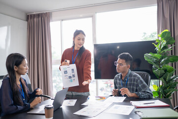 Asian business woman Application Designers presenting trending products report mobile application planning process development software design project ux Graphic designer