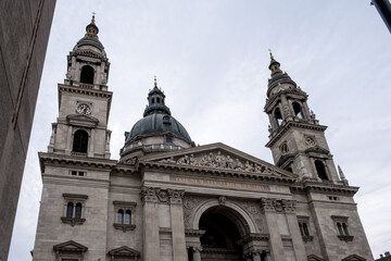 Budapest, Hungary – Architectural detail of St. Stephen’s Basilica, showcasing its neoclassical façade, ornate columns, sculpted tympanum, and twin bell towers. A symbol of faith and grandeur.