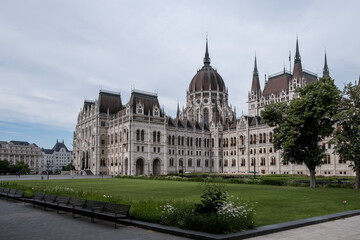 Budapest, Hungary – Architectural detail of the Hungarian Parliament Building (Országház), showcasing Neo-Gothic ornamentation, pointed arches, spires, and intricate stone carvings.