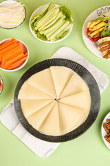 Healthy Meal Prep with Whole Wheat Pancakes and Fresh Vegetables on Green Background