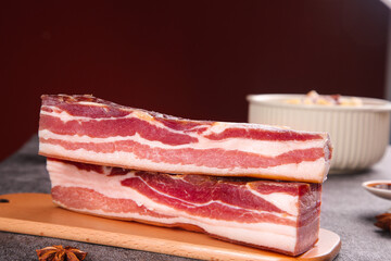 Raw Bacon Strips with Marbled Fat on Wooden Cutting Board - Premium Pork Belly Meat