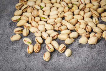 Fresh Pistachio Nuts with Green Kernels on Dark Background - Healthy Snack Food