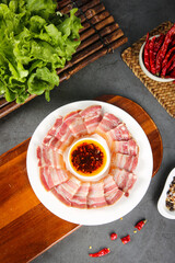 Sliced Smoked Pork Pancetta with Sauce and Fresh Vegetables on Wooden Board