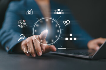 Time management concept. A person touching clock icon on virtual to work planning for increases efficiency and reduces work time. Business project planning.