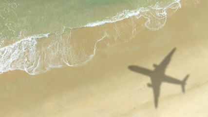 Aerial view of shadow passenger plane silhouette and sandy beach blue sea with waves at sea beach summer vacation sea travel concept	