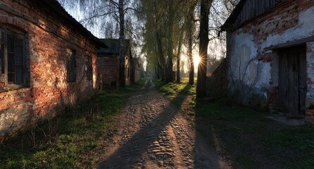 Obraz premium Sunlit path between weathered brick buildings