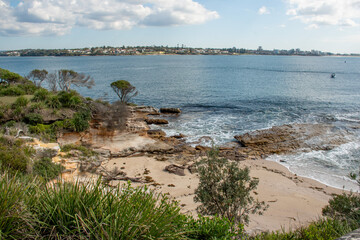 Beautiful ocean and rocky sandstone coastline view. Travel destination. Royal National Park, NSW, Australia. Jibbon Loop Track near Little Jibbon Beach